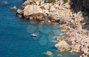 Small boat near coastal rocks of Adriatic Sea, Montenegro