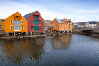 Red and yellow wooden houses in Norwegian fishing village. Rorvik, Norway