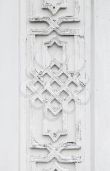Vintage white wooden wall with Arabic ornament decoration, background photo texture