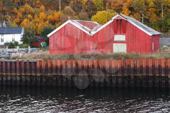 Traditional Norwegian red wooden barns stand on the sea coast.  Hasselvika village in the municipality of Rissa in Sor-Trondelag county, Norway