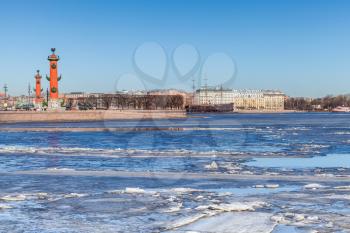 Winter landscape with rostral columns and floating ice on Neva river in St.Petersburg, Russia