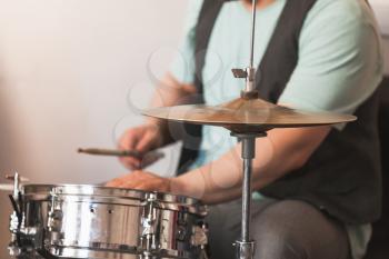 Live music background, drummer plays on a snare drum, close-up photo with selective soft focus