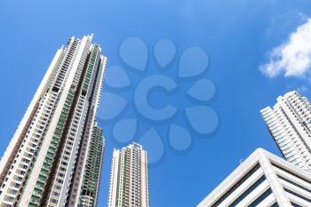 Urban skyline with skyscrapers under blue sky. High-rise concrete towers. Living houses of Hong Kong