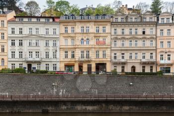 Colorful living houses facades along Tepla river coast. Karlovy Vary town, Czech Republic