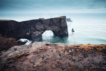 Natural rocky arch. Scenic landscape of Dyrholaey Nature Reserve, south coast of Iceland, Europe