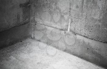 Abstract interior fragment of an empty concrete room, corner of gray stone walls and floor