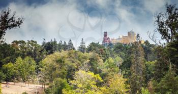 Panoramic summer landscape with Pena Palace on the top of the Sintra Mountains. Popular landmark of Portugal