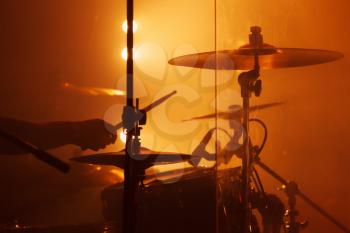 Live music background, drum set with cymbals and drummer hand 