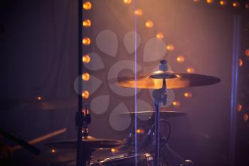 Live music photo, drum set with cymbals and stage lights on a background