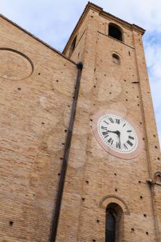 Old clock tower. San Agostino cathedral of Fermo, Italy