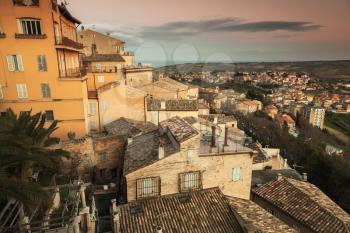 Cityscape of Fermo, old Italian town. Vintage stylized photo with warm tonal correction