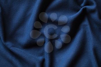 Wavy texture of blue fleece, soft napped insulating fabric made from polyester, wavy pattern