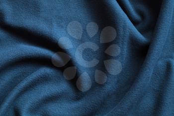 Texture of fleece, blue soft napped insulating fabric made from polyester, wavy pattern
