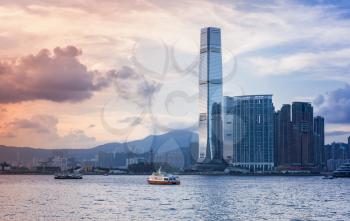 Modern cityscape with skyscrapers. International Commerce Centre of Hong Kong under colorful evening sky
