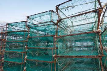 Traps for crabs stacked in fishing port of Busan, South Korea. Boxes with green net