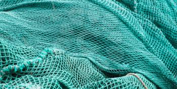 Drying green fishing net, background photo with selective focus and shallow DOF