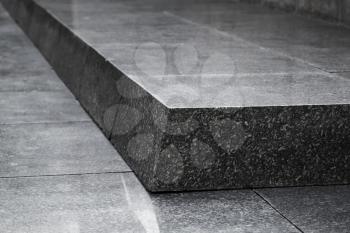 Black granite stair corner, abstract architecture fragment. Close-up photo with selective focus