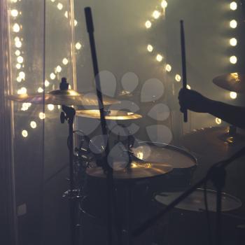 Live rock music background, drum set with cymbals and drummer hand 
