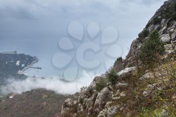Crimea, Black Sea coast. Rocks and clouds. Landscape of Laspi in foggy spring morning