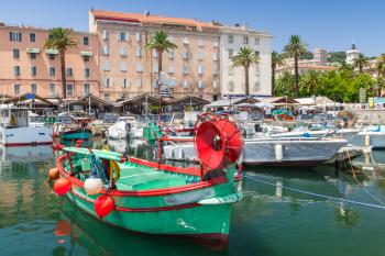 Colorful wooden fishing boats moored in old port of Ajaccio, Corsica, the capital of Corsica, French island in the Mediterranean Sea