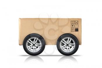 Cardboard box with standard signs and automotive wheels isolated on white background, fast delivery concept metaphor 