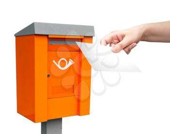 Orange metal post box and female hand with white letter