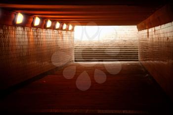 Underground passage with lights and stairs in glowing end