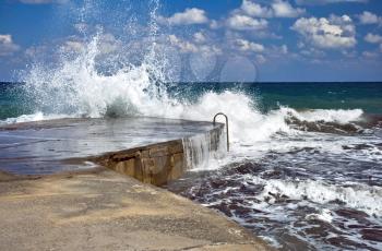 Sparks of breaking wave in the Mediterranean sea. Crete island, Greece