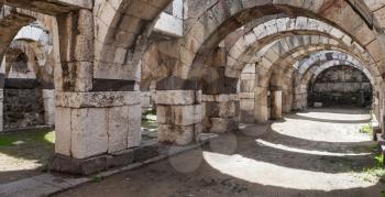 Empty stone arcade with columns. Ruins of Ancient city Smyrna. Izmir, Turkey. Panoramic photo
