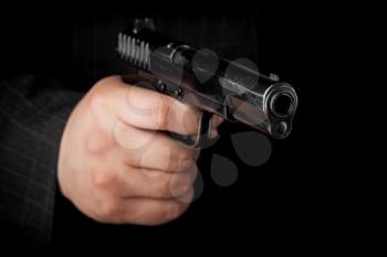 Closeup photo ob black pistol in male hand
