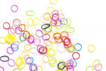Small round colorful rubber bands for making rainbow loom bracelets isolated on white background