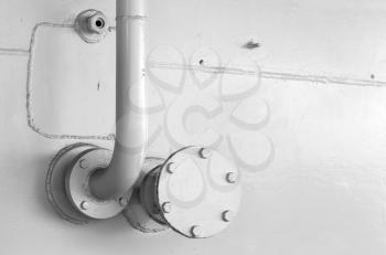 Abstract industrial background with white naval wall and fragment of tubing