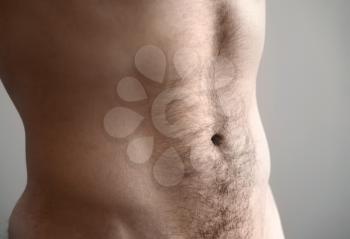 Flat man's belly. Closeup photo with shallow depth of field