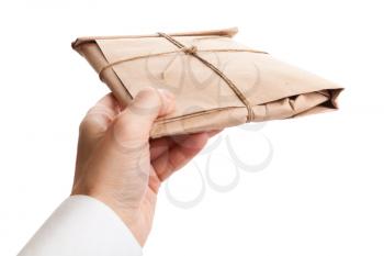 Male hand delivers full envelope tied with a rope isolated on white background