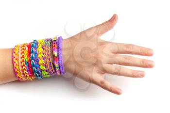 Child hand with colorful rubber rainbow loom bracelets isolated on white, trendy teenagers fashion accessories 