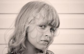 Monochrome portrait of a little blond beautiful Russian girl above white wall background