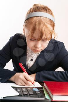 Portrait of blond Caucasian girl doing homework