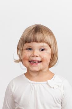 Smiling Cute Caucasian little girl, closeup studio portrait on light gray background