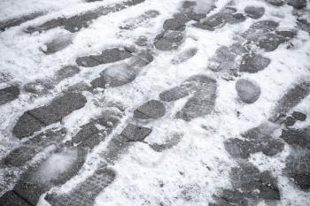 Footprints in wet fresh snow on the street
