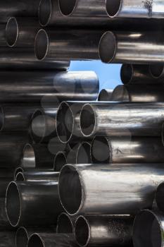 Shining metal tubes, abstract industrial background photo with selective focus