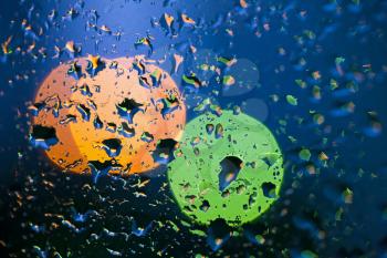 Beautiful abstract colorful background with water drops over window glass