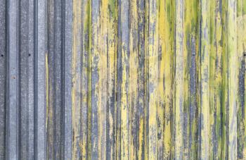 Ridged yellow painted old metal wall background texture