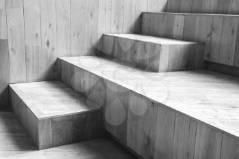 Abstract empty interior fragment, natural wooden stairs. Black and white photo with selective focus