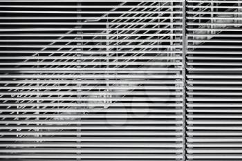 Abstract steel constructions, modern industrial architecture fragment, stairs behind shutters
