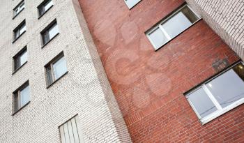 Abstract urban architecture fragment, gray and red brick walls with windows