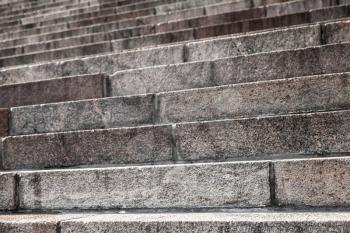 Abstract architecture fragment. Old stairway made of granite stone blocks, close up photo with selective focus
