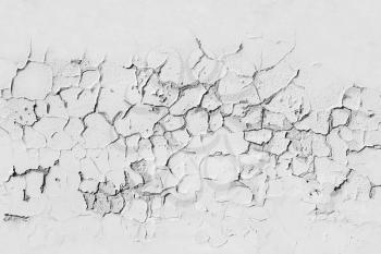 White concrete wall with cracked flaking paint layer, background texture with seamless composition