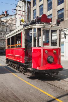 Old red tram goes on Istiklal street to Taksim square in Istanbul, popular tourist transport