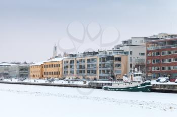 Winter cityscape of Turku, Finland. Small ship moored near main embankment