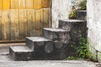 Abstract rural architecture fragment, old concrete stairs near wooden wall